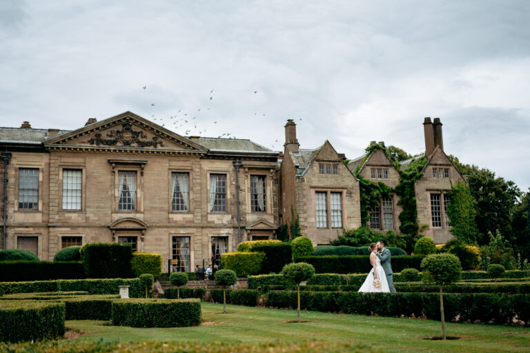 Bride and groom walking the grounds of a West Midlands wedding venue Coombe Abbey