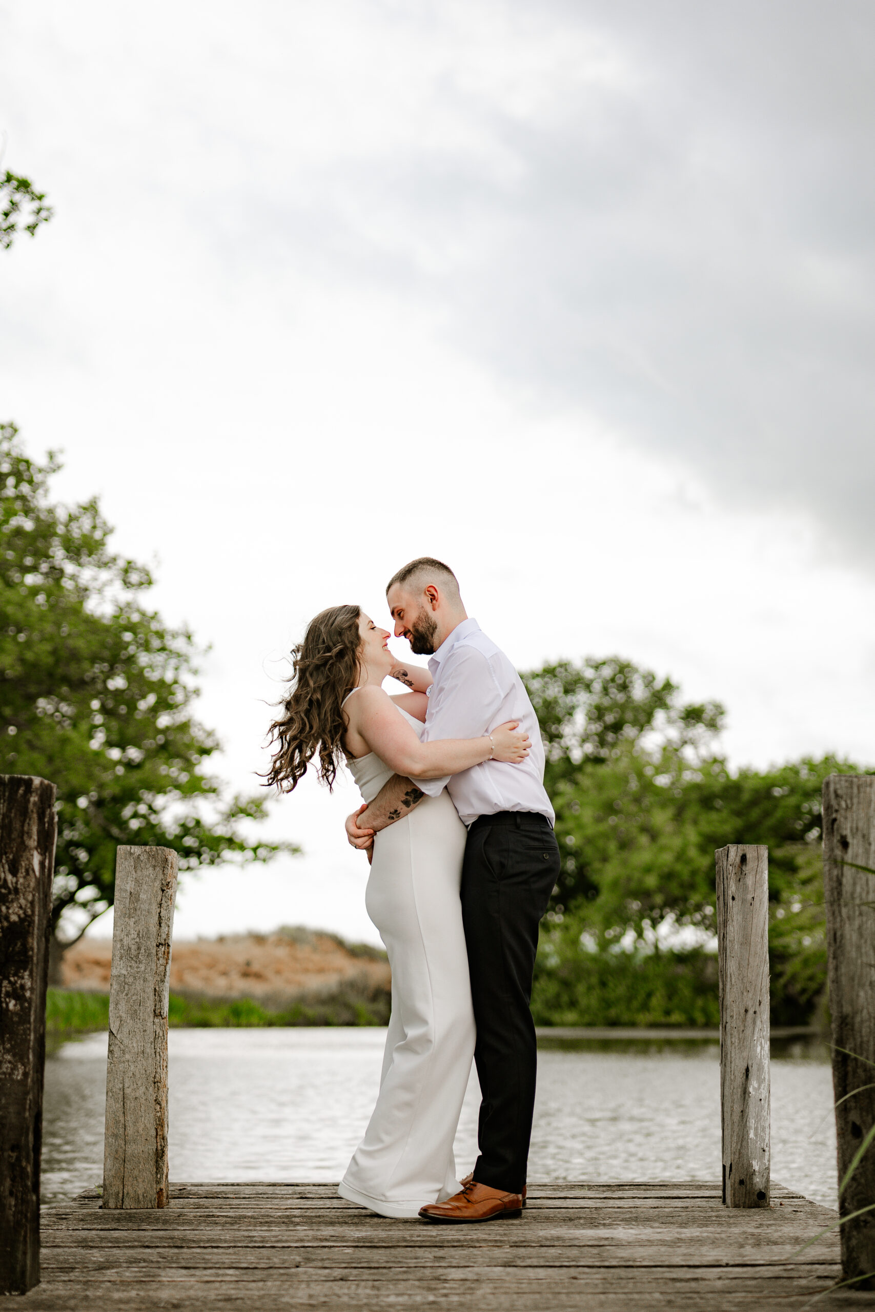 Bride and Groom walking through the fields candid wedding photography - shropshire wedding venue Moat House Barns