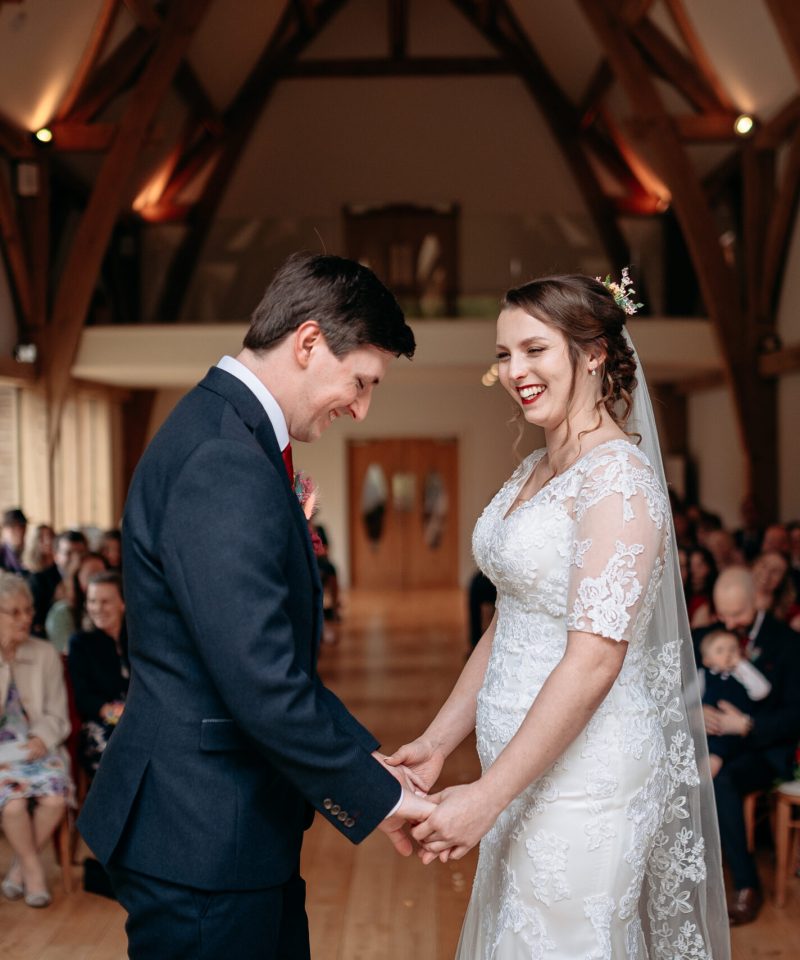 Bride and groom beaming after their ceremony at The Mill Barns