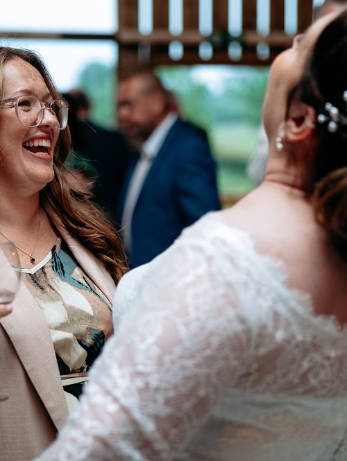 Candid moment of guests laughing during a relaxed wedding day