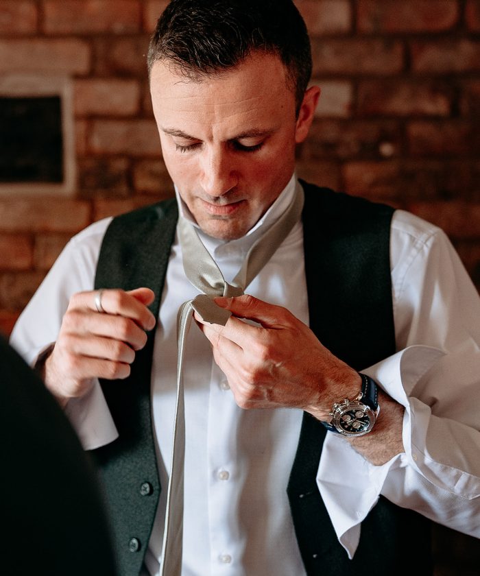 Groom getting ready photographed by Morrells Wood wedding photographer