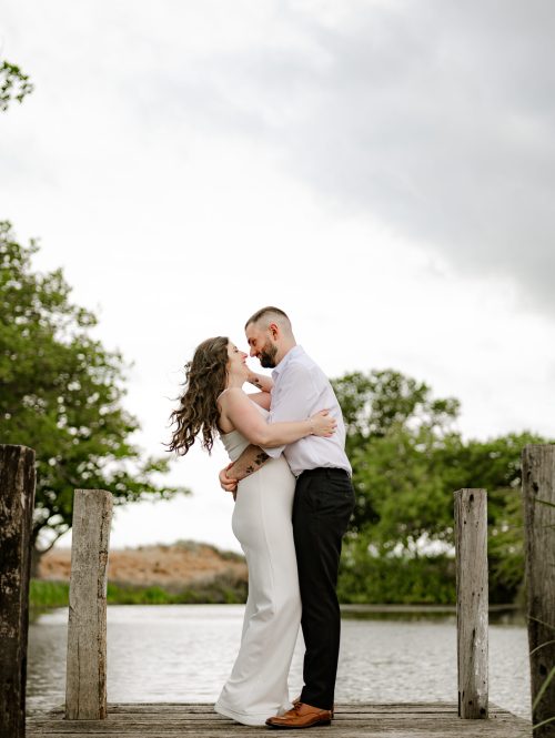 Bride and Groom walking through the fields candid wedding photography - shropshire wedding venue Moat House Barns