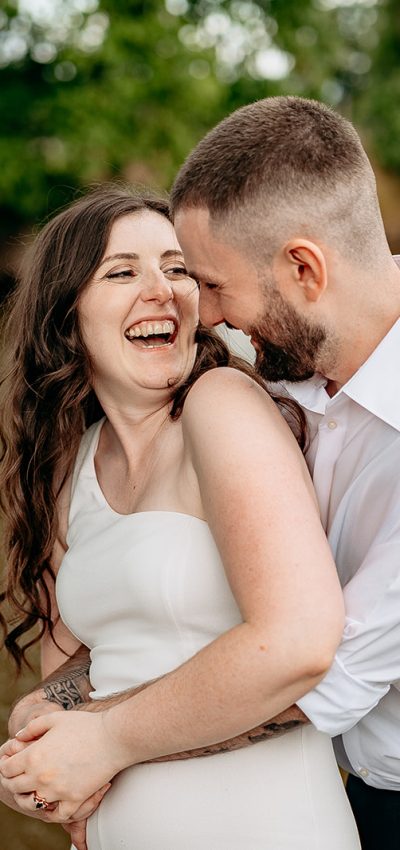 Bride and groom laughing candidly during countryside wedding in Shropshire