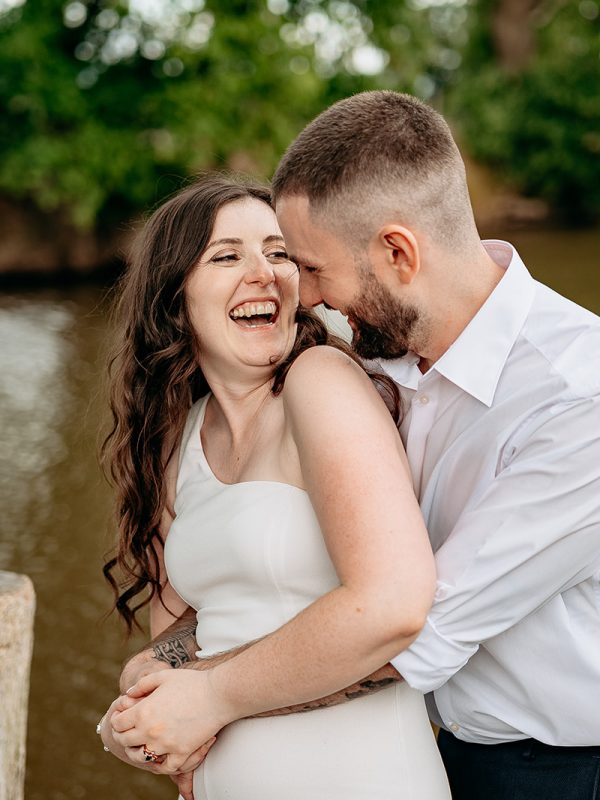 Bride and groom laughing candidly during countryside wedding in Shropshire
