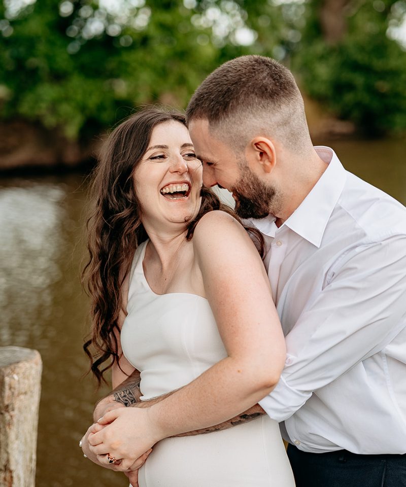 Bride and groom laughing candidly during countryside wedding in Shropshire